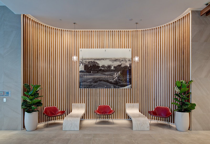 Precise illumination of the lobby features at 40 Miller Street, including grazing timber panelling on curved walls with Aduro CL.