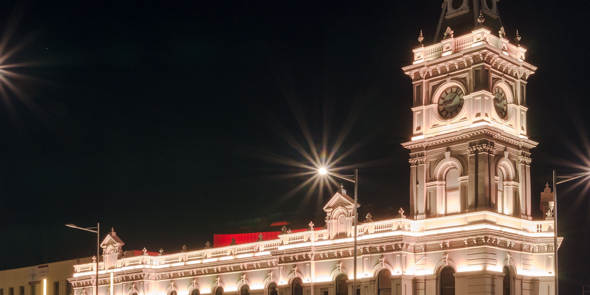 Latitude LED luminaire in application, installed on the façade of the former Dandenong Town Hall, now known as the Drum Theatre in Melbourne. Night view.