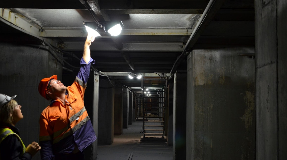 Coolon Tunnel Ray LED industrial lighting installed on a copper mine in northern queensland. View on a mining electrician adjusting the industrial light.