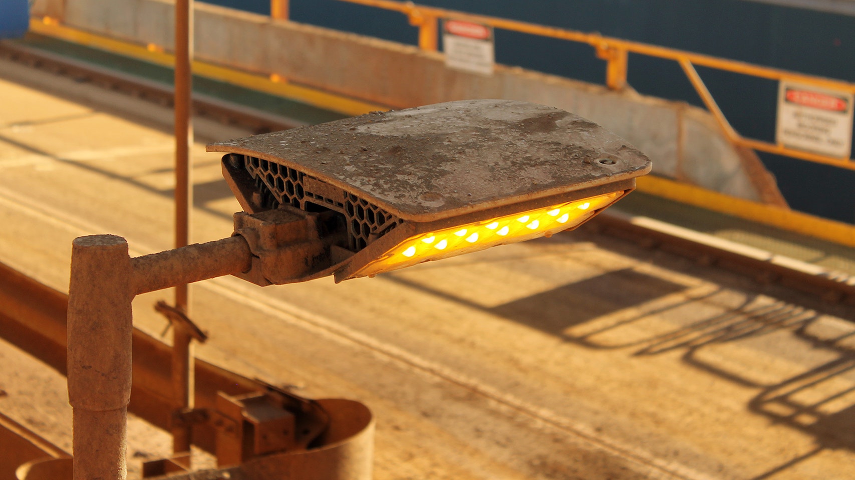 DLK LED Conveyor / Area Light in application, installed on a conveyor on an iron ore mine in bulk port, close up photo
