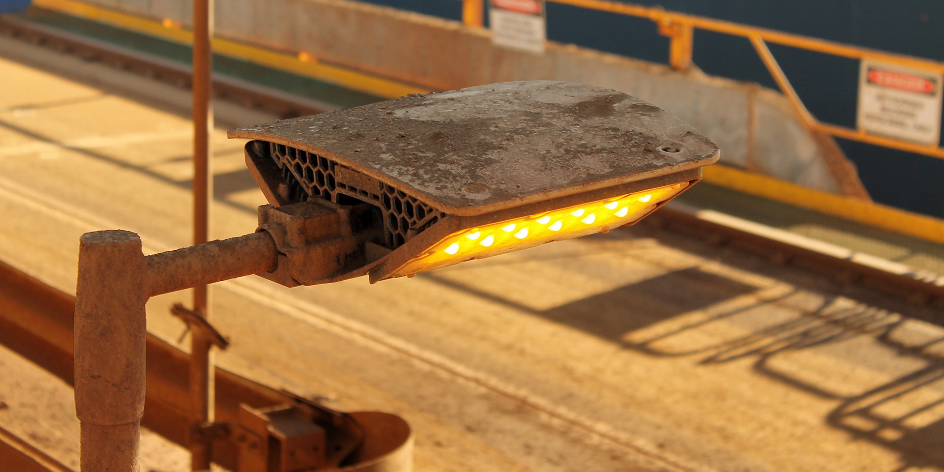 DLK LED Conveyor / Area Light in application, installed on a conveyor on an iron ore mine in bulk port, close up photo